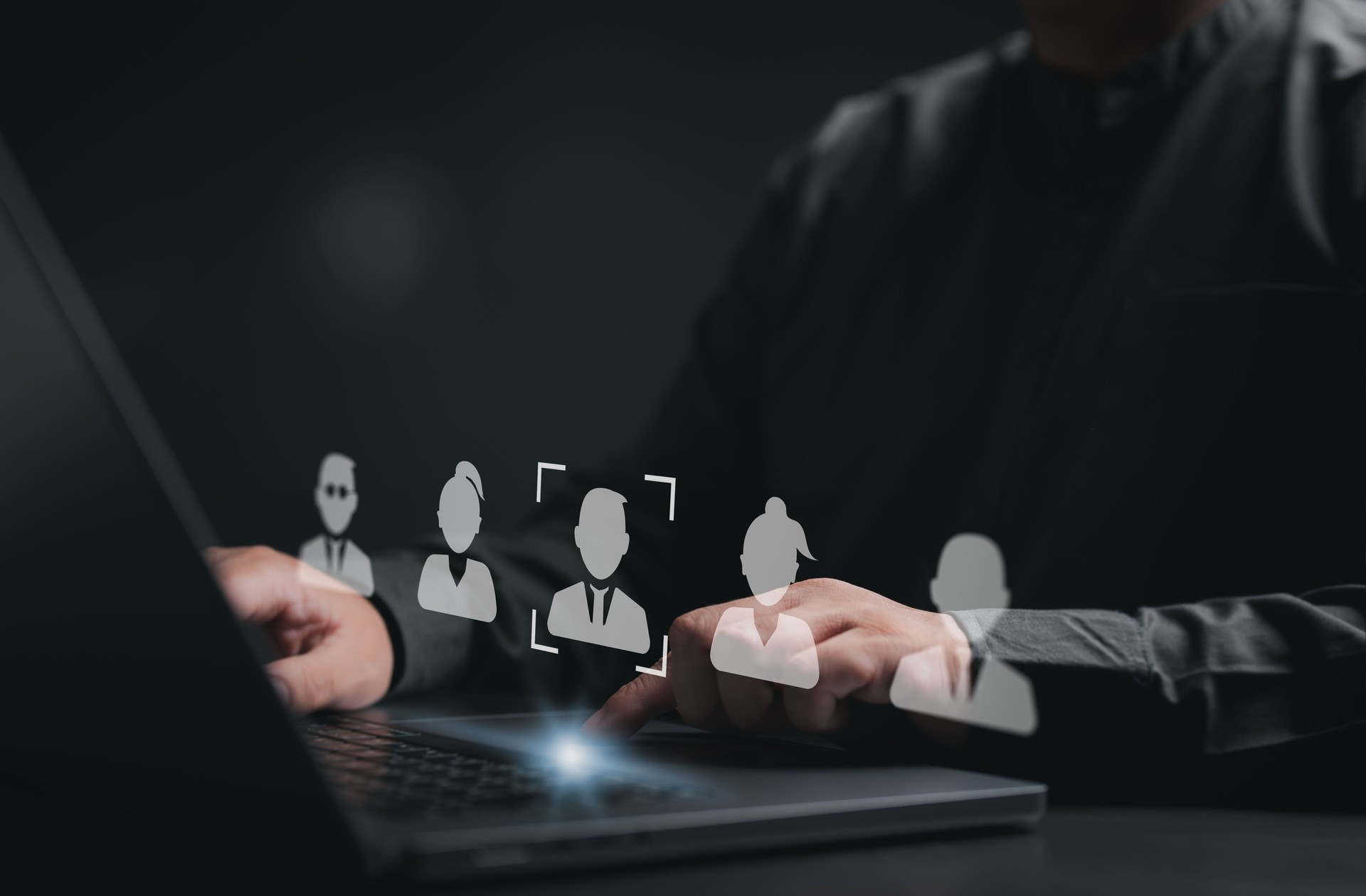 Human Resource Management or HRM concept. Businessman use computer laptop to pick human icons for human development and recruitment concepts. Search an expert specialist person to join the team.